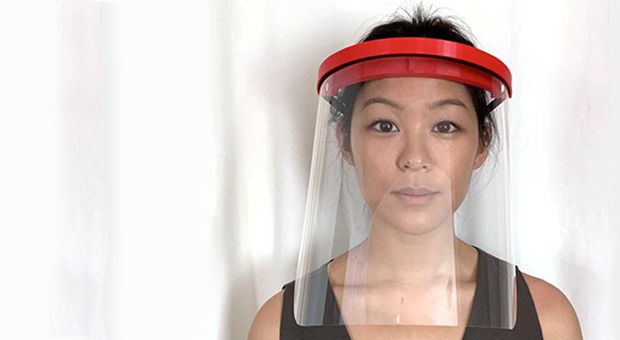 A photo of a woman wearing a face shield made using 3D printers