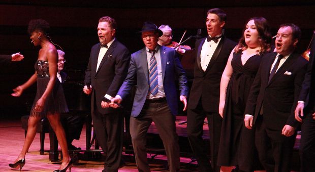 Aubrey Dan and Craig Walker perform at centre stage alongside Queen's drama and music students and alumni.