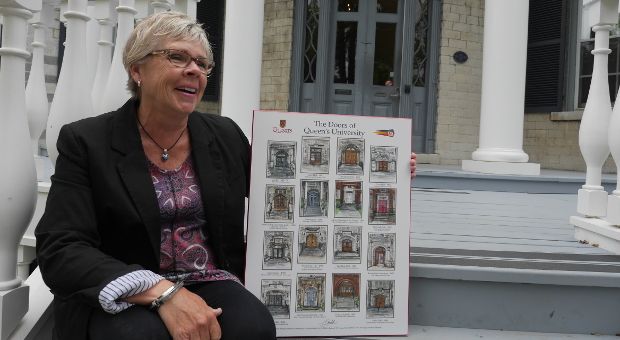 Judith Gould holds her Doors of Queen's poster