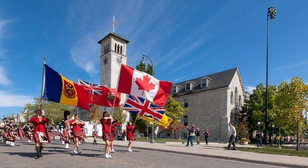 Queen's bands marching in front of Grant Hall