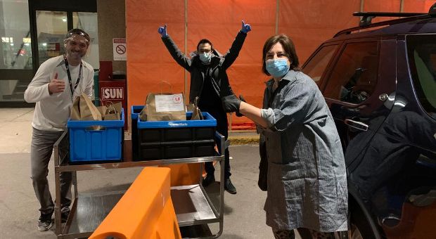 A photo of Adair Roberts making a delivery to health-care workers 