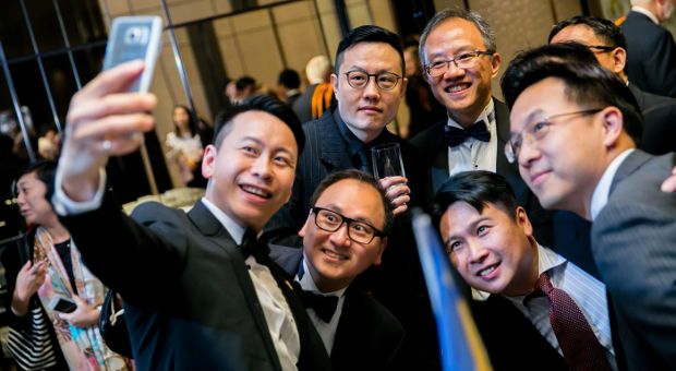 Alumni taking a photo together at the Hong Kong reception 