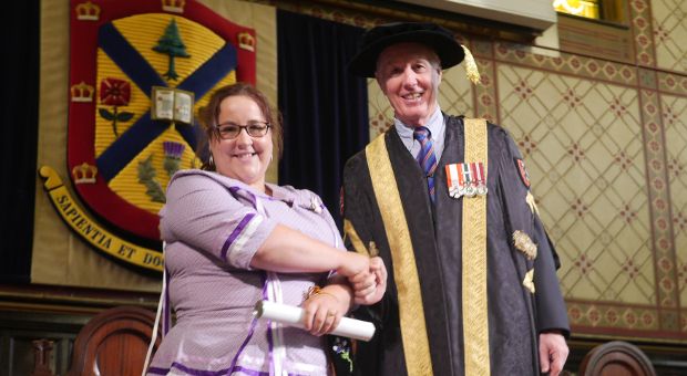 [Melanie Gray with Chancellor Jim Leech at Convocation]