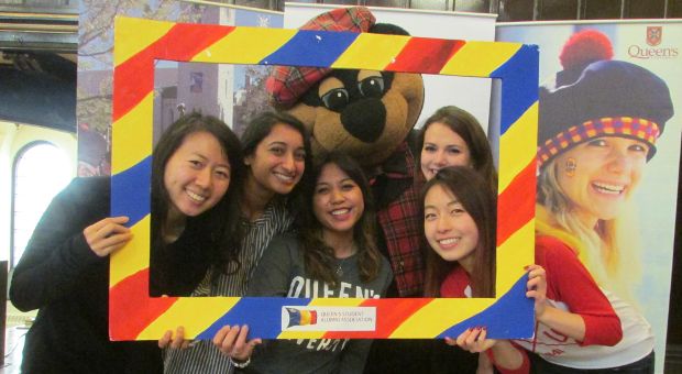 New grads posing with Boo Hoo