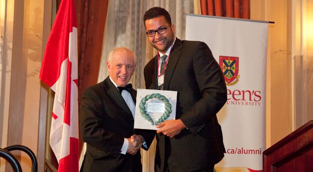 [Photo of Zhaodi Culbreath presenting the John Orr Award to John Rae]