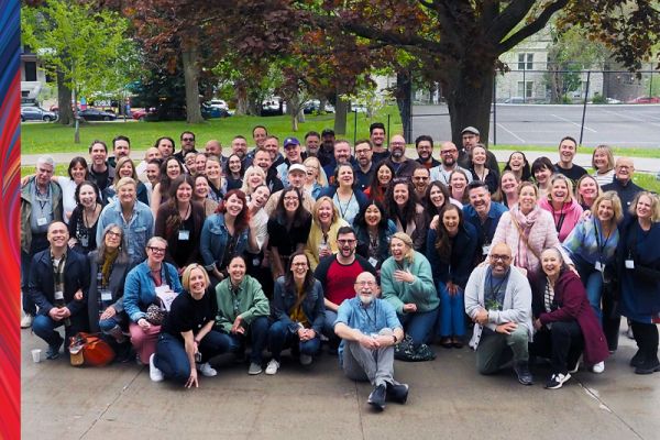 photo of a group of people outside, people are standing, sitting or kneeling 