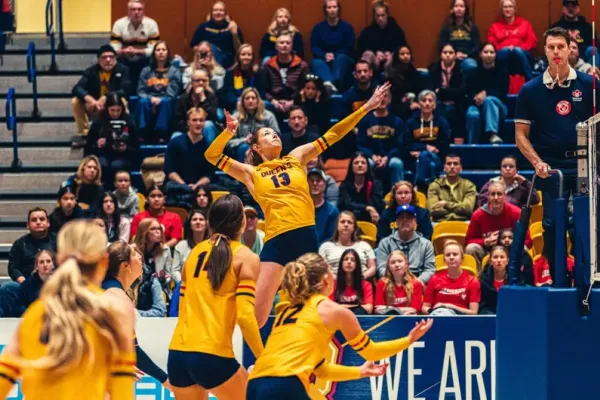 Abigail McAlpine from Queen's University jumps up for a spike near the net.