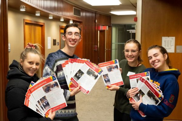 Civil Engineering students hold program guides to studying engineering. 