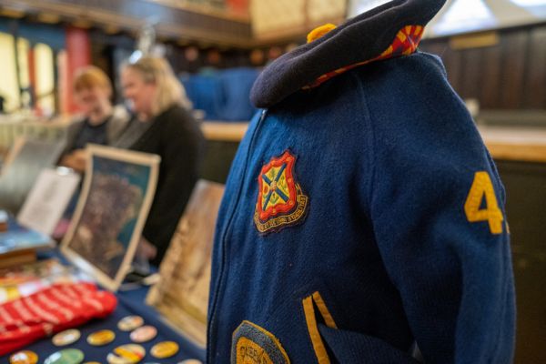 Queen's jacket and tam on a display table