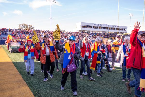 alumni walk the field at halftime