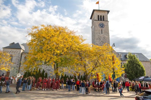 Queen's Bands and alumni gather outside of Grant Hall