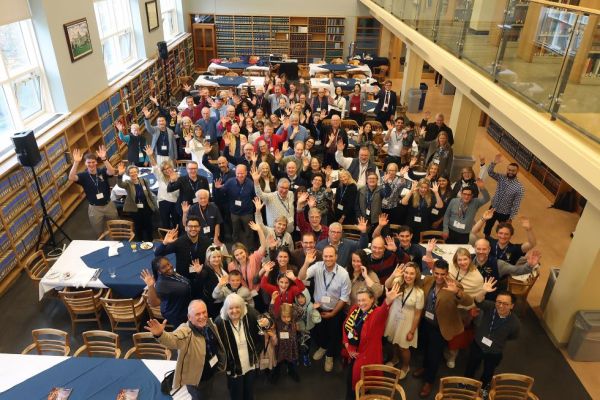 aerial shot of law alumni pose in the law library 