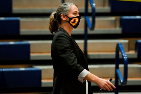 Claire Meadows wearing as mask watching a sporting event
