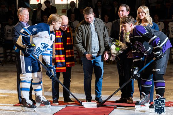 Brock Powell (centre) dropping the puck before the game, with Stephen J.R. Smith to his right. 