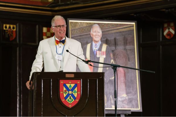 Chancellor Emeritus Jim Leech, MBA’73, stands in front of his official portrait during his farewell celebration in Grant Hall on June 24.