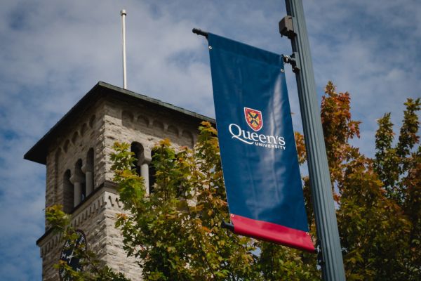 Grant Hall with a Queen's University flag.