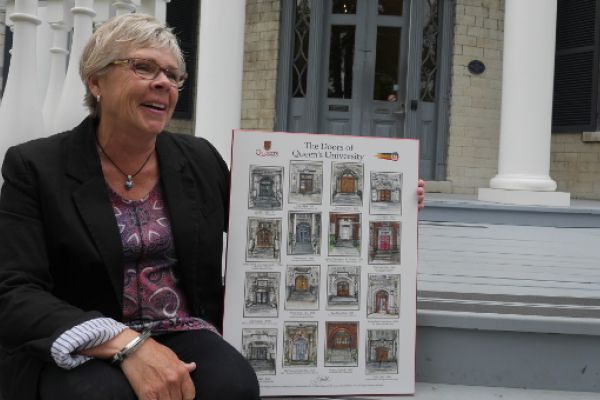 Judith Gould holds her Doors of Queen's poster