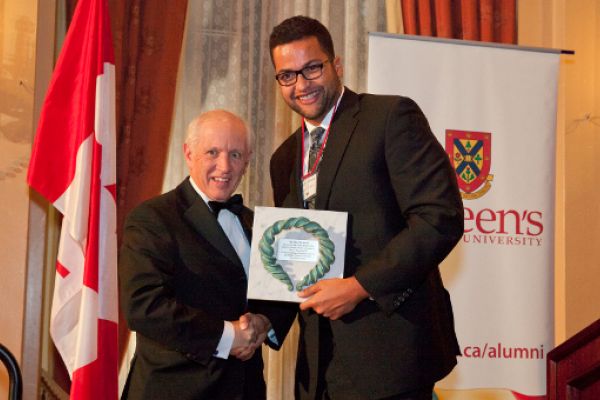 [Photo of Zhaodi Culbreath presenting the John Orr Award to John Rae]