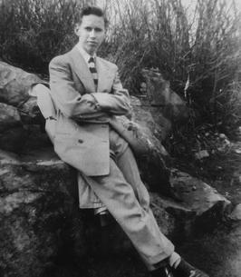 Photo of Roger Burton Stotts, leaning against a rock, in the early 50s.