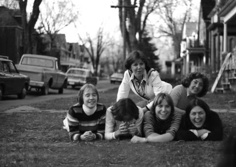 Former residents of 1 Aberdeen St. in the ’70s, lying on the lawn.