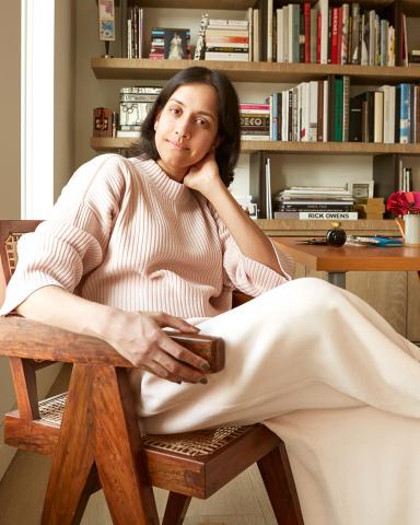 Anjli Patel leaning back in a chair, smiling at the camera