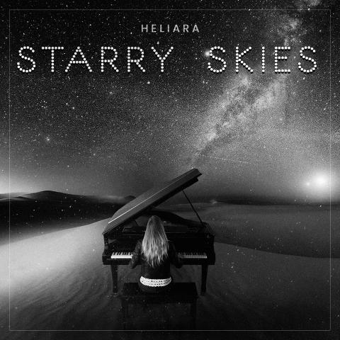 Album cover of a woman playing a piano in the desert with a sky full of stars.