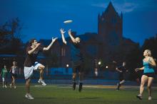 Students play ultimate frisbee on Tindall Field