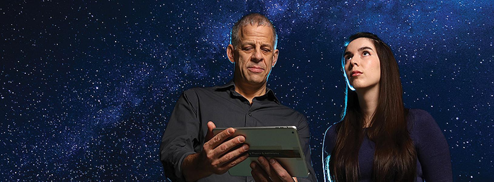 Professor Stéphane Courteau and PhD student Nathalie Ouellette looking up at the stars