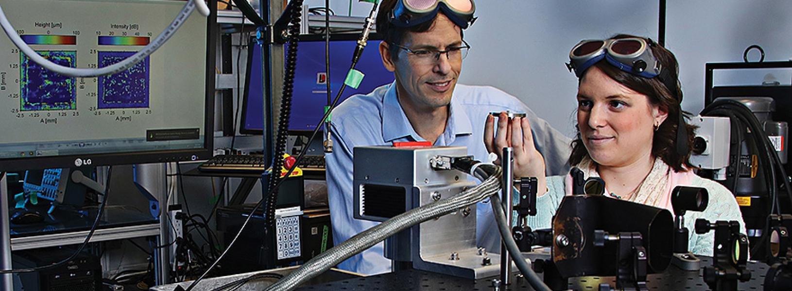 Professor James Fraser and master’s student Allison Sibley, in a lab, studying light.
