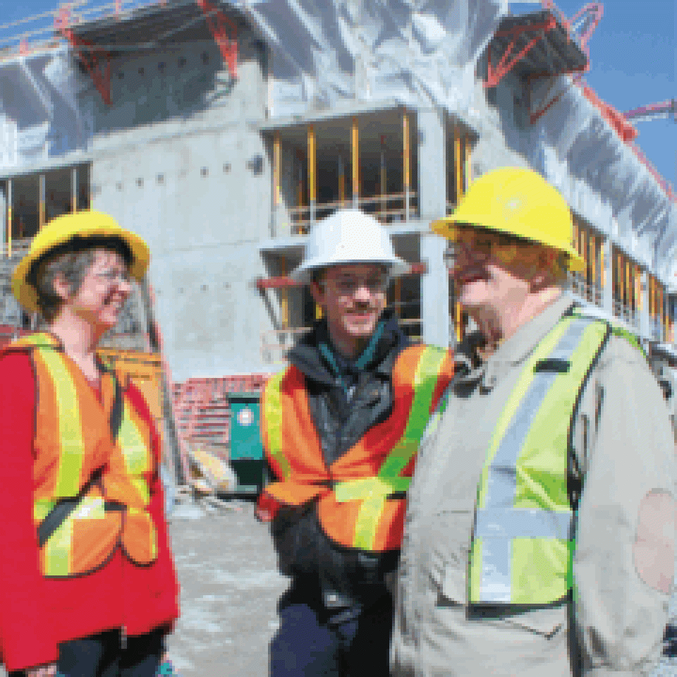 Writer Kirsteen MacLeod, Journal sports editor Andrew Bucholtz, Artsci’09 (centre), and Professor Stewart Fyfe, Arts’49, on their recent tour of the Queen’s Centre construction site