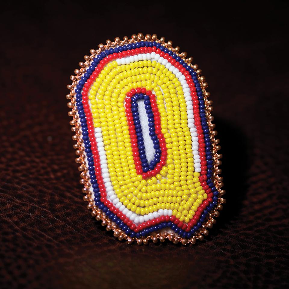 A beaded capital letter Q done in a traditional way.