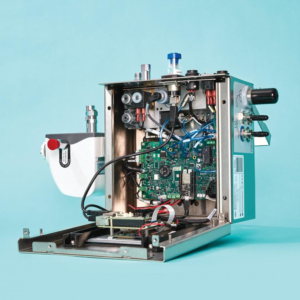 A ventilator that is open to show the electronics inside