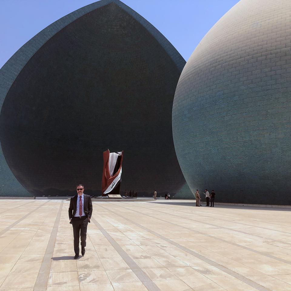 Greg Galligan standing in front of the Al-Shaheed Monument in Baghdad.
