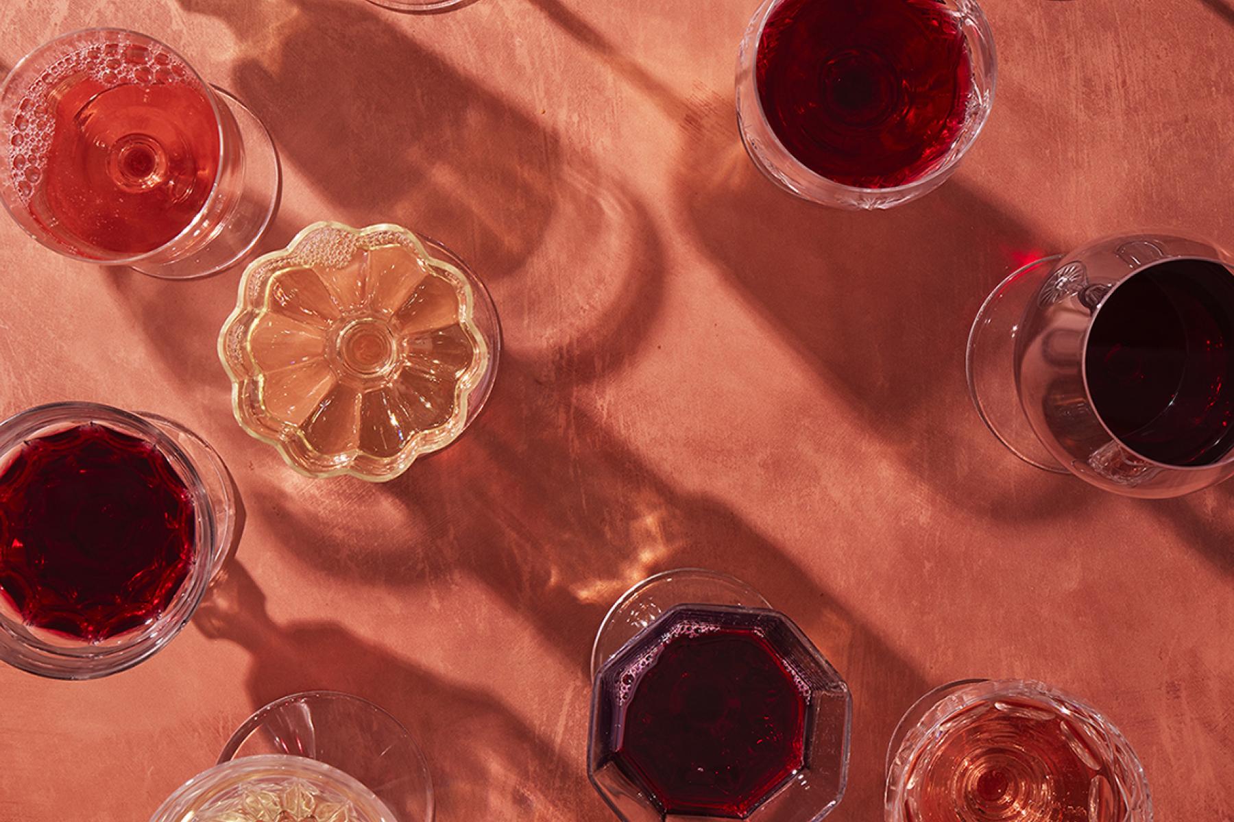 An overview of wine glasses filled with wine.