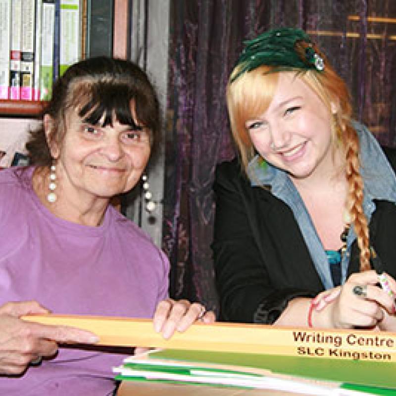 Shannon Hope Gendron, Artsci'10 sitting at a table with a Writing Centre client.