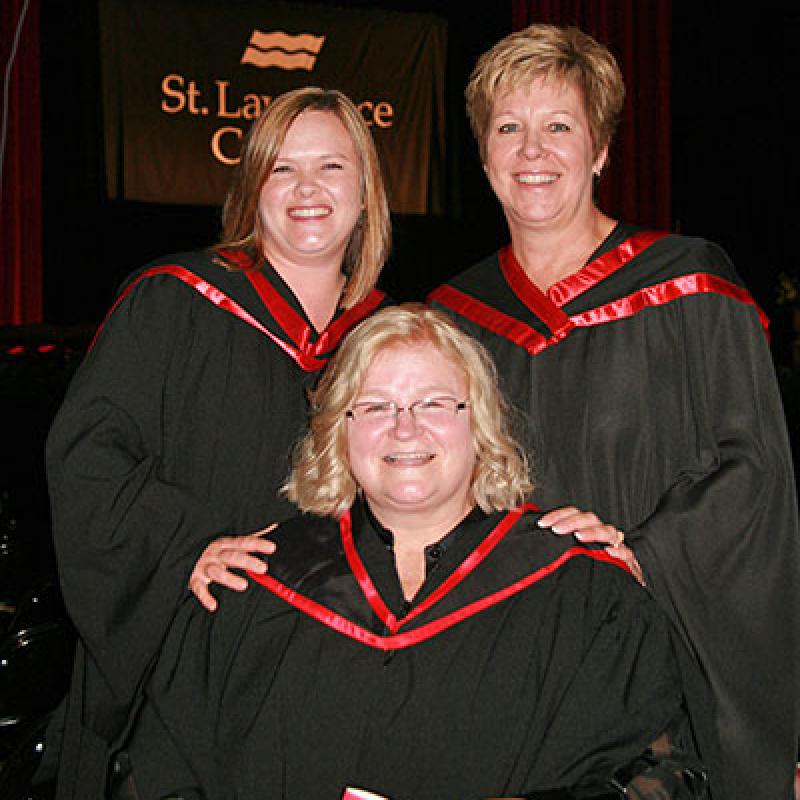 Meaghan Shaver, Terri McDade, and Lorraine Carter posing for a photo at graduation.