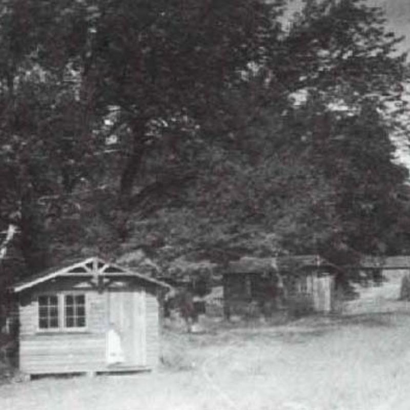 Black and white photo of small wooden cabin
