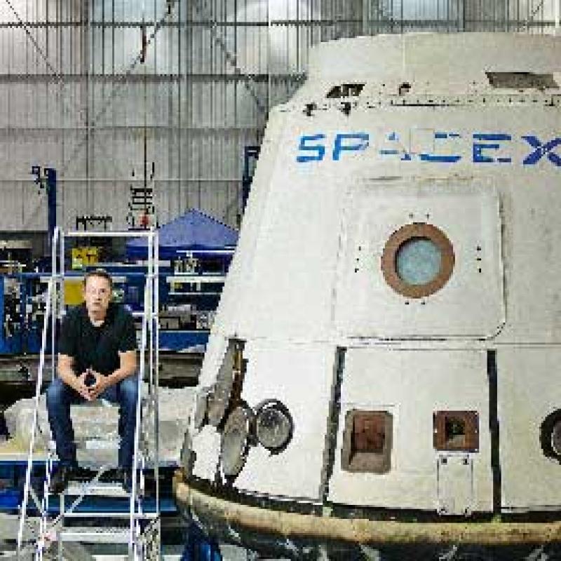 Elon Musk with a Dragon space capsule (Photo courtesy of Space X.)
