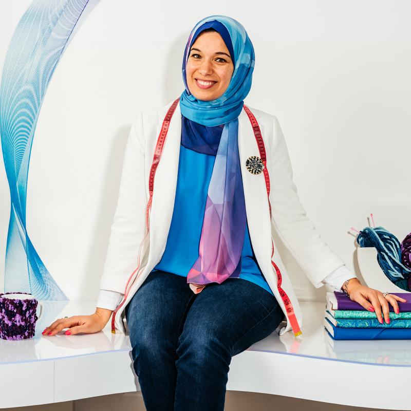 Dr. Sara Nabil sitting on a bench in the iStudio.