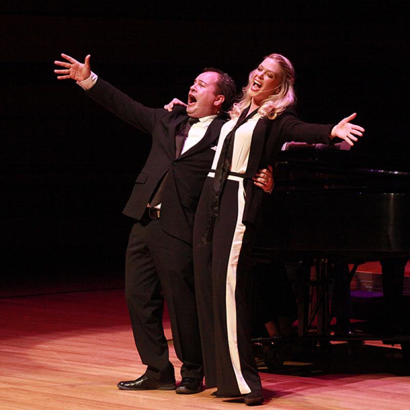 two people on stage singing