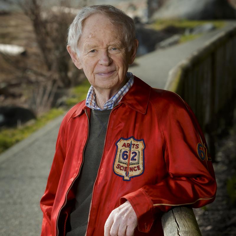 Stewart Goodings leaning against a fence rail wearing his 1962 Queen's jacket.