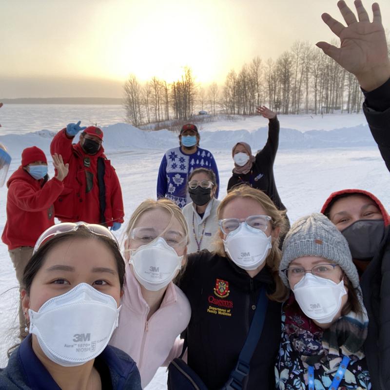 A group of people wearing face masks taking a selfie