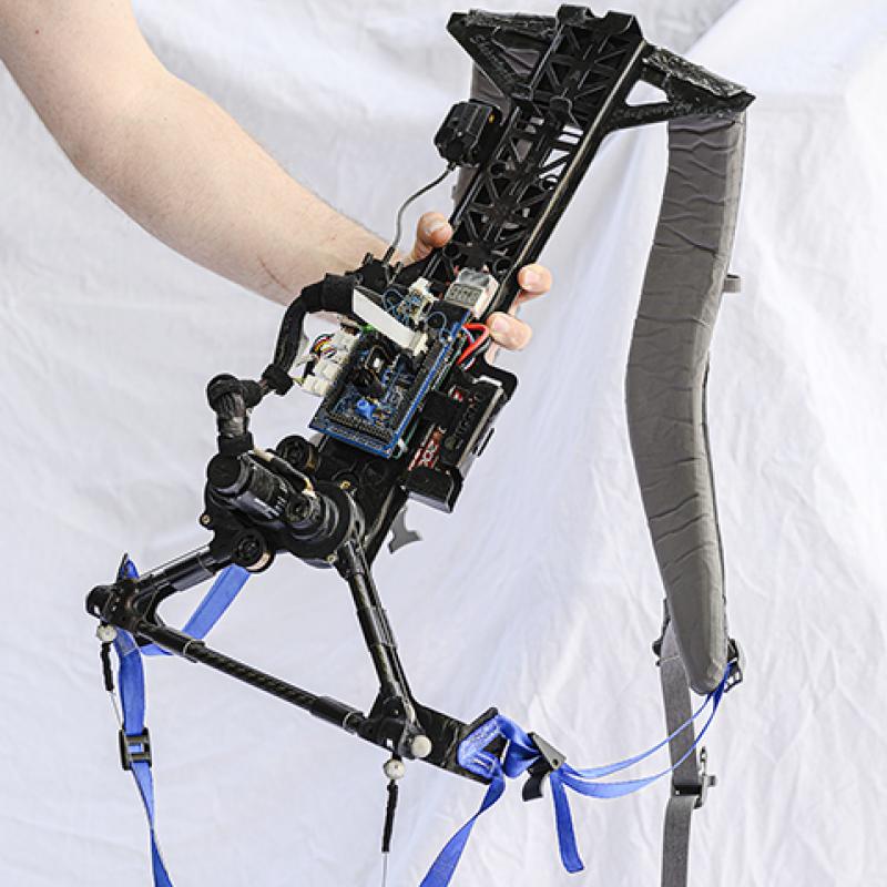 Photo of arm holding the exoskeleton backpack