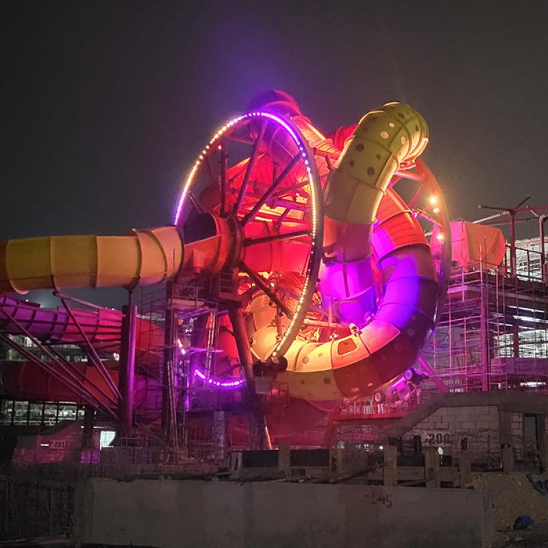 A view of a waterslide under construction at night