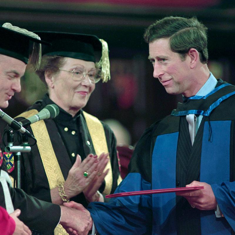 Prince Charles shakes a man's hand as he accepts his Queen's doctorate of laws in October 1991.