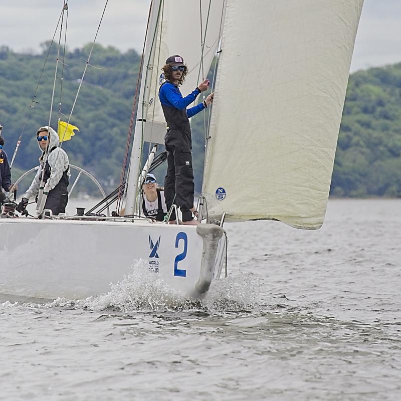 Members of the Oakcliff Black sailboat crew train on a smaller boat. 