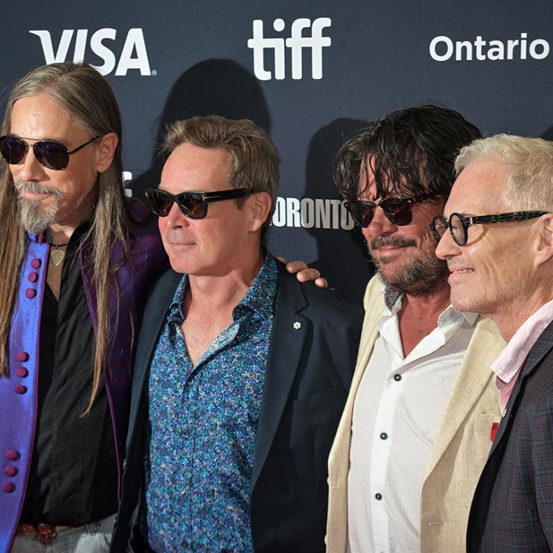 Rob Baker, Gord Sinclair, Paul Langlois, and Johnny Fay pose for photos at the Toronto International Film Festival.