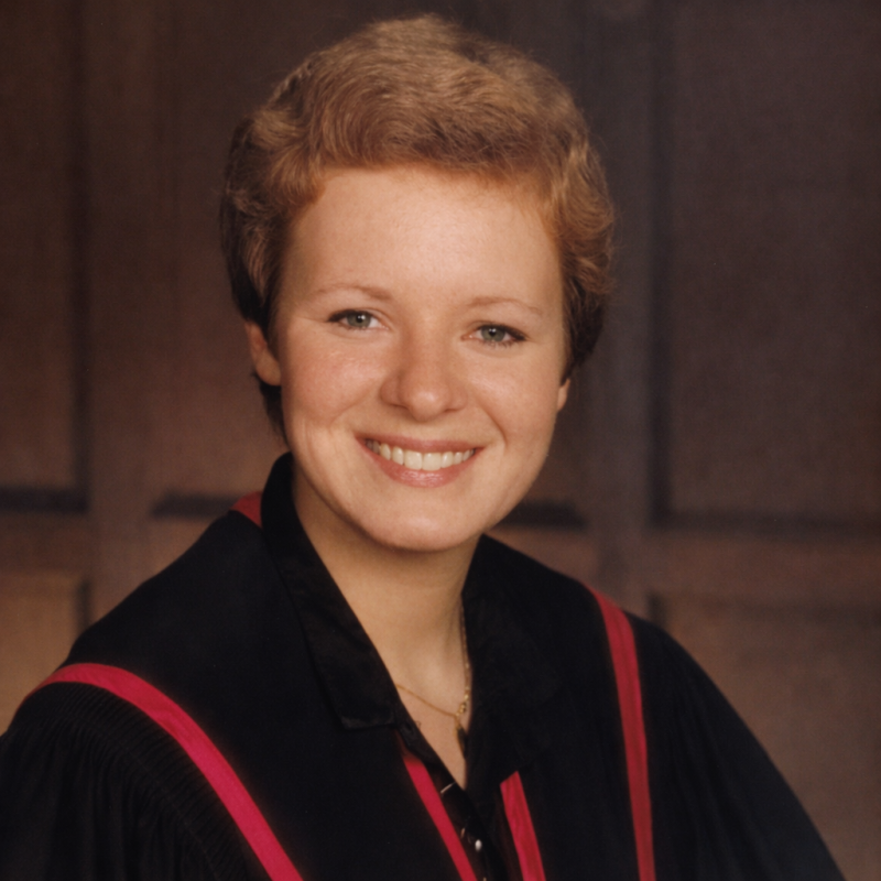 Formal portrait of a smiling Julie Epplett in academic robes.