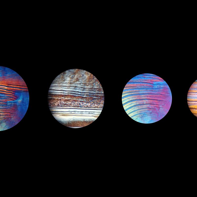 Four microscopic views of plant-derived cellulose nanocrystals forming colourful layered patterns.