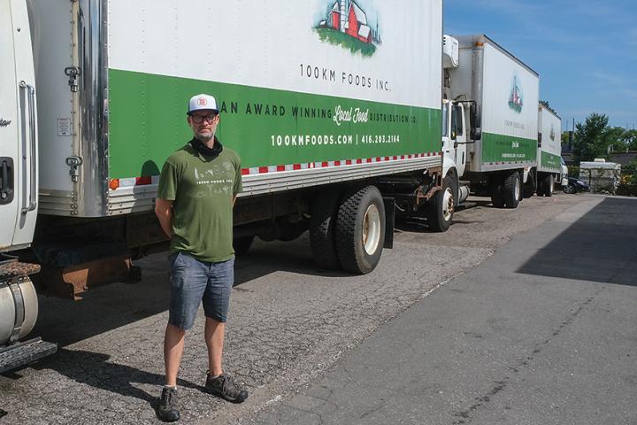 Paul Sawtell in front of a large delivery truck